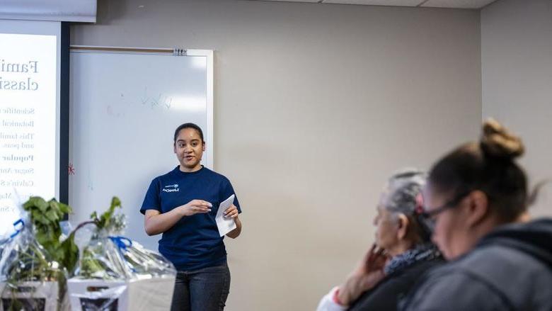 Student presents vegetable research to community members